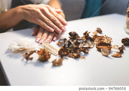 Delicate female hands with a beautiful french manicure. Nail polish. Delicate female hands with a beautiful french manicure. Nail polish. 94766058