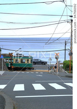 Enoden train passing the railroad crossing Enoden train passing the railroad crossing 94766092