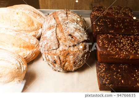 Showcase with Different Kinds of Fresh Hand Made Bread. Bakery. 94766635