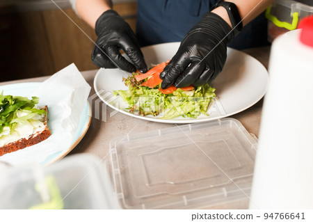 Sheaf making vegetable salad with smoked salmon in restaurant. Healthy food. Sheaf making vegetable salad with smoked salmon in restaurant. Healthy food. 94766641
