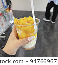Gal with ice parfait with lots of fresh mango 94766967