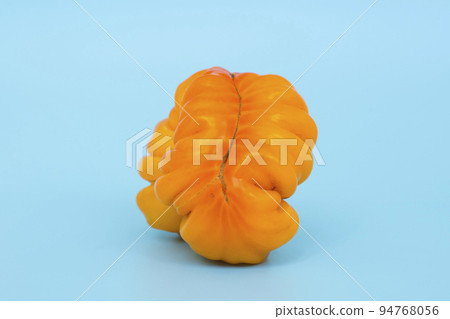 Ugly vegetables concept. Tomatoes of various unusual shapes on a blue minimal background. A metaphor for imperfection, the female body, the art of photography and form. Ugly vegetables concept. Tomatoes of various unusual shapes on a blue minimal background. A metaphor for imperfection, the female body, the art of photography and form. 94768056