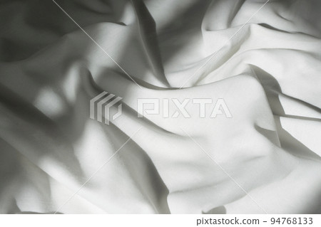 White drapery linen fabric background. Texture of the light surface of the fabric. 94768133