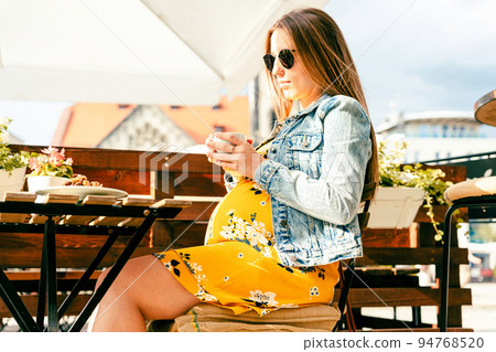 Drink coffee pregnant woman. Happy pregnancy girl drink hot coffee in restaurant. Represent breakfast for energy and freshness concept. Drink coffee pregnant woman. Happy pregnancy girl drink hot coffee in restaurant. Represent breakfast for energy and freshness concept. 94768520