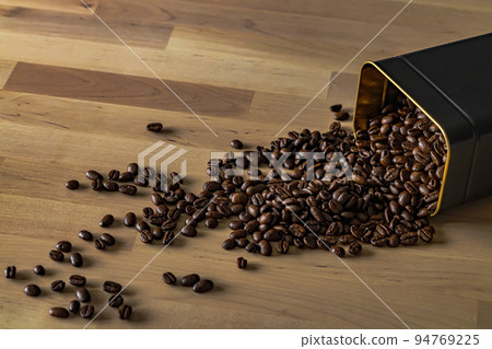 Close-up of roasted coffee beans on wooden background Close-up of roasted coffee beans on wooden background 94769225