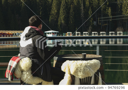 Man sitting and relaxing outdoor in resort Man sitting and relaxing outdoor in resort 94769296
