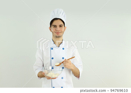 Concept of cooking, young man chef on light background 94769610
