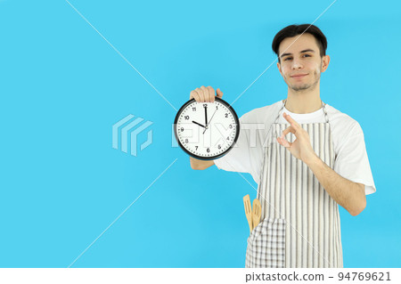 Concept of cooking, young man chef on blue background Concept of cooking, young man chef on blue background 94769621