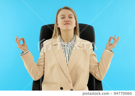 Young and attractive business woman on blue background 94770060