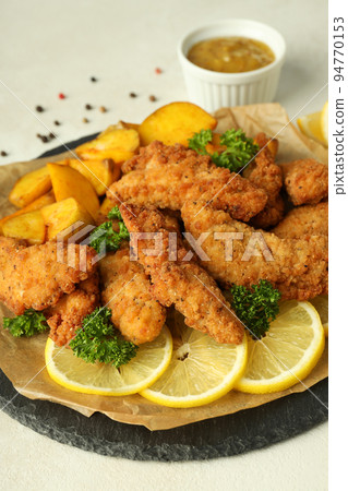 Concept of tasty food with chicken strips, close up Concept of tasty food with chicken strips, close up 94770153