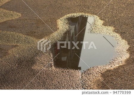small pond at street with building reflection 94770399