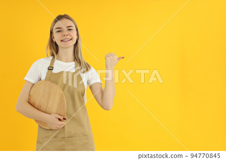 Concept of occupation, young female waiter on yellow background 94770845