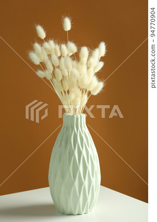 Hygge concept, dried flowers against brown background Hygge concept, dried flowers against brown background 94770904