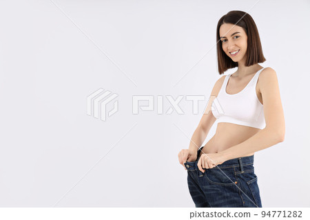 Concept of weight loss, young woman on light background 94771282