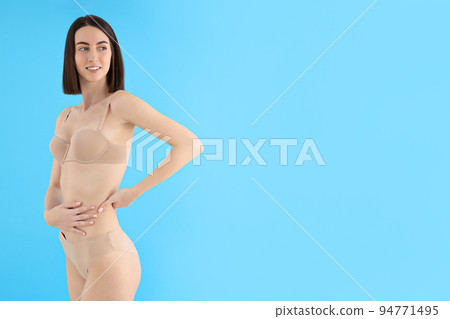 Concept of weight loss, young woman on blue background Concept of weight loss, young woman on blue background 94771495