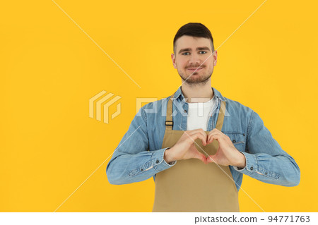 Concept of occupation, young waiter on yellow background 94771763