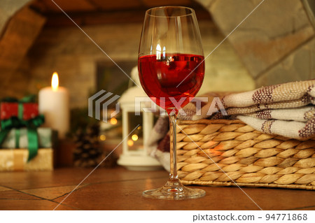 Composition with glass of wine in cozy winter evening Composition with glass of wine in cozy winter evening 94771868