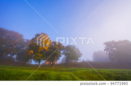 Autumn foggy landscape of Lithuanian historic capital Kernave, foggy landscape of Kernave mounds Autumn foggy landscape of Lithuanian historic capital Kernave, foggy landscape of Kernave mounds 94771993