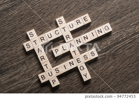 Conceptual business keywords on table with elements of game making crossword 94772453