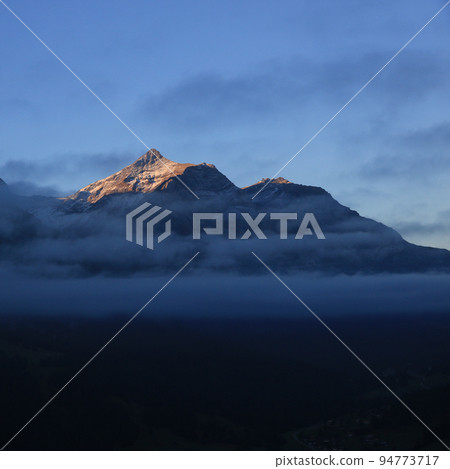 Sunlit peak of Mount Oldehore in early morning. Sunlit peak of Mount Oldehore in early morning. 94773717