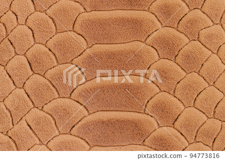 Texture of genuine leather close-up, embossed under skin of brown reptile, croco. natural background 94773816