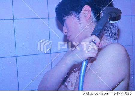 Woman taking a shower Woman taking a shower 94774036
