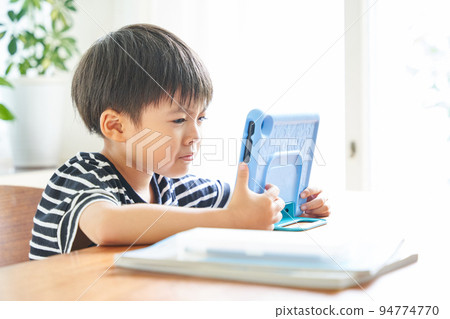 boy learning with tablet at home 94774770