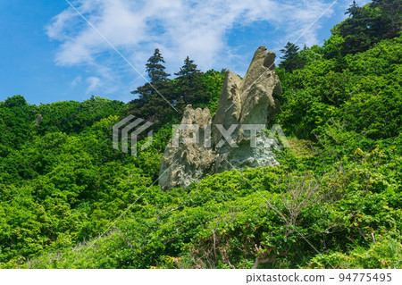 coastal landscape, beautiful lava rocks on the green coast of Kunashir island coastal landscape, beautiful lava rocks on the green coast of Kunashir island 94775495