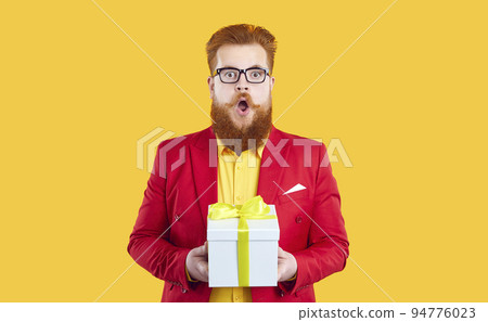 Funny chubby redhead bearded young man in red jacket and glasses gets amazing present Funny chubby redhead bearded young man in red jacket and glasses gets amazing present 94776023