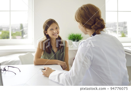 Happy teenage child patient having a medical consultation with a doctor in the clinic Happy teenage child patient having a medical consultation with a doctor in the clinic 94776075