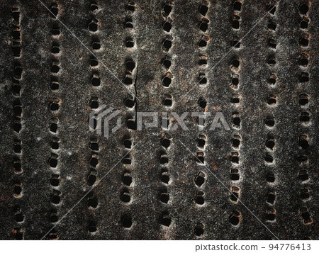 old rusty iron sheet with holes as a background 94776413