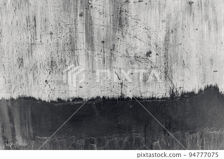 Grunge abstract beautiful monochrome black and gray wall with cracks in the plaster and several levels of paint application. Background with space for text or image. The art of rough stylized texture 94777075