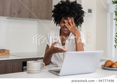 Happy businesswoman raising palm to forehead and smiling Happy businesswoman raising palm to forehead and smiling 94777496