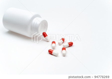 medicine bottle and capsules on a white background. 94778269