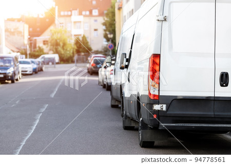 Small cargo delivery van parked in european city central district. Medium lorry minivan courier vehicle deliver package at residential office building in downtown area. Commercial shipping logistics 94778561
