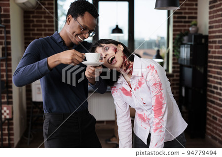 Evil cruel zombie chatting with man in office, brain eating monster with bloody scars and ugly wounds being in startup business workplace. Woman evil corpse talking to businessman. Evil cruel zombie chatting with man in office, brain eating monster with bloody scars and ugly wounds being in startup business workplace. Woman evil corpse talking to businessman. 94779494