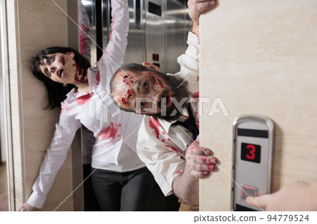 Couple of walkers leaving elevator to attack people in business office, walking dead horror apocalypse with devil possessed zombies . Eerie dramatic corpses brain eating monsters at workplace. Couple of walkers leaving elevator to attack people in business office, walking dead horror apocalypse with devil possessed zombies . Eerie dramatic corpses brain eating monsters at workplace. 94779524