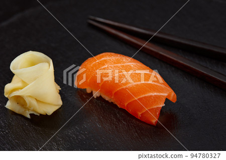 tasty sushi with salmon on a wooden board 94780327