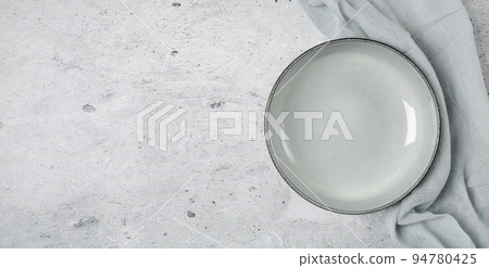 Empty black slate plate on grey stone table and napkin. Empty black slate plate on grey stone table and napkin. 94780425