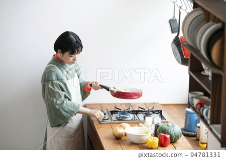 Young woman cooking 94781331