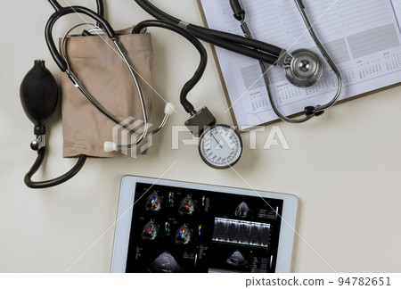 As the doctor checks his results on the tablet, the echocardiography ultrasound of the heart examination will be analyzed in order to prescribe the right treatment 94782651