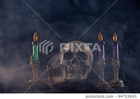 Halloween human skull on an old wooden table over black background. Shape of skull bone for Death head on halloween festival which show horror evil candle smoke fear and scary, copy space Halloween human skull on an old wooden table over black background. Shape of skull bone for Death head on halloween festival which show horror evil candle smoke fear and scary, copy space 94783693