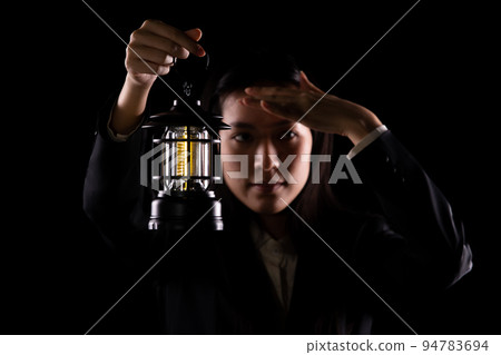 Business Woman hold light lamp lantern as lead the way out of problem, idea solution creativity inspire innovation success glowing your imagination invention. Concept Vision exit, copy space Business Woman hold light lamp lantern as lead the way out of problem, idea solution creativity inspire innovation success glowing your imagination invention. Concept Vision exit, copy space 94783694
