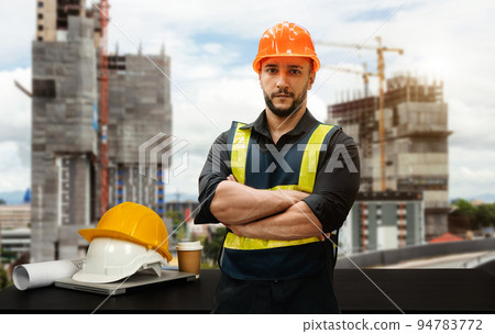 Handsome young man architect on a building industry construction site in sun light Handsome young man architect on a building industry construction site in sun light 94783772