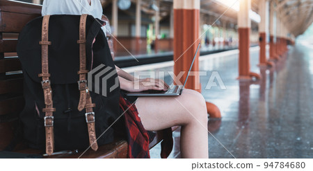 Image of Young asian freelance working at train station before travel. summer work and travel concept Image of Young asian freelance working at train station before travel. summer work and travel concept 94784680