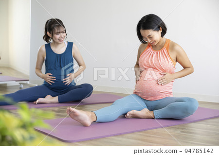 Maternity yoga image Two smiling pregnant women 94785142