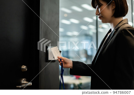 Career woman entering security zone Career woman entering security zone 94786007