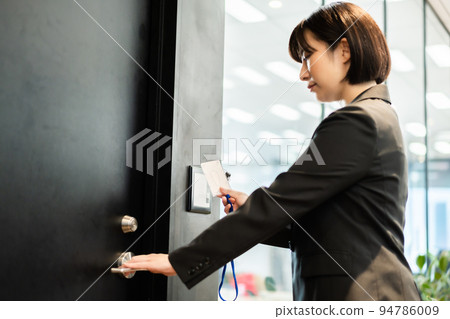 Career woman entering security zone Career woman entering security zone 94786009