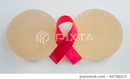 Breast implants and satin ribbon. Breast cancer awareness symbol. 94786023