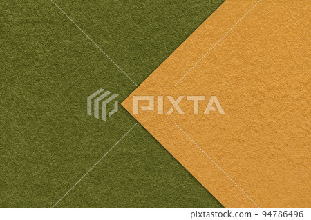 Texture of dark green paper background, half two colors with yellow arrow, macro. Craft olive cardboard. Texture of dark green paper background, half two colors with yellow arrow, macro. Craft olive cardboard. 94786496